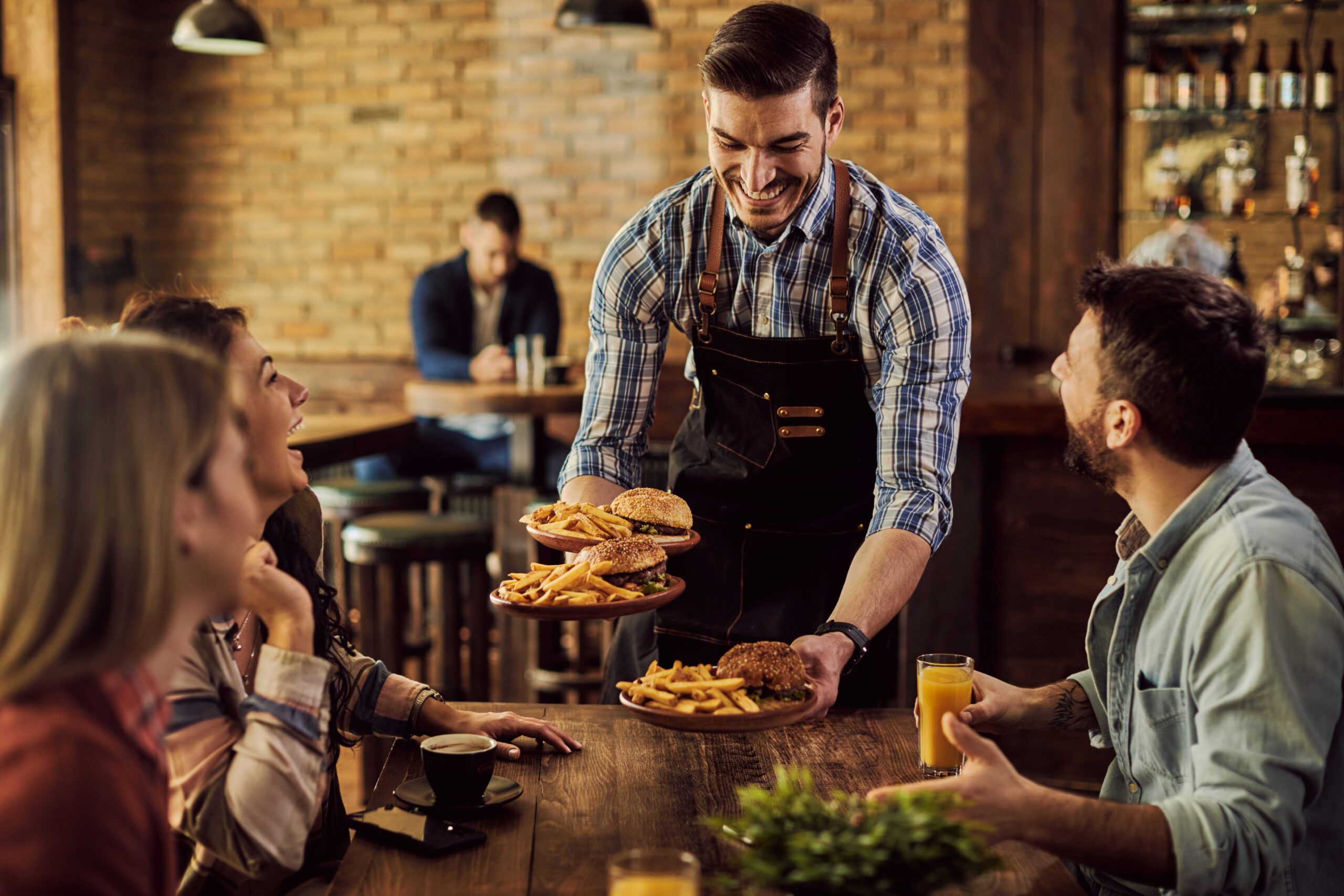 happy waiter serving food group cheerful friends pub scaled