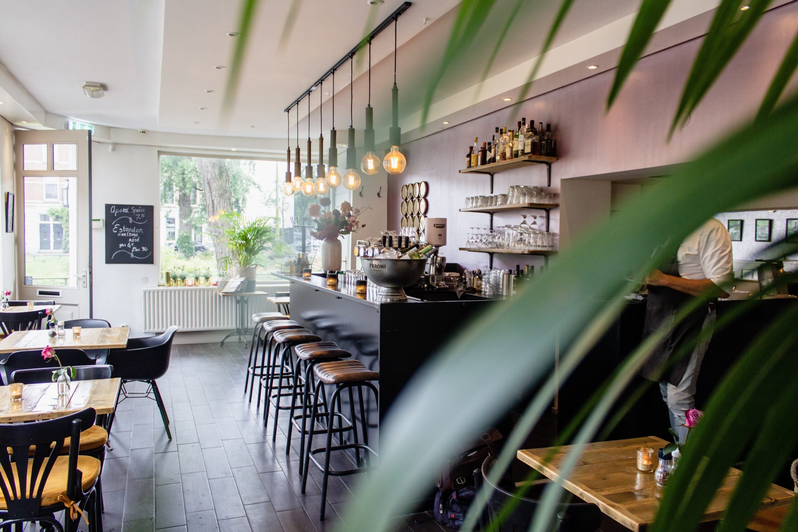 interior shot cafe with chairs near bar with wooden tables scaled